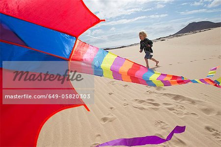 Boy flying kite on beach