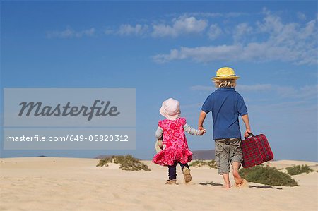 Frères et sœurs marcher ensemble sur la plage