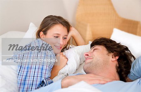 Smiling couple relaxing in bed