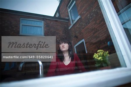 Disappointed woman standing in kitchen