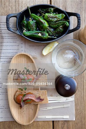 Crisp bread with herrings and tomatoes,grilled green peppers