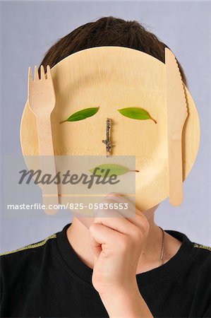 Child playing with a wooden plate