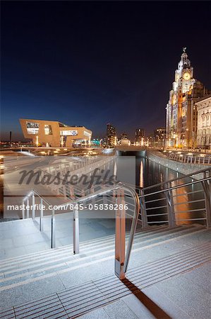Dusk at The Liver Building and new Ferry Terminal Building, a new branch of the Beatles Story Museum at the The Canal Link, Pier Head in Liverpool, Merseyside, England, UK