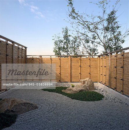 Minimalist gravel garden with fencing