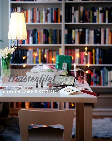 Making Christmas cards on a desk with a lit lamp.