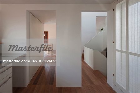 House in Musashiseki, Private House, View of the dining room on the left and the staircase on the right, seen from the kitchen. Architects: Yasushi Horibe Architect