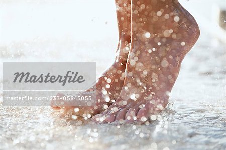 Feet under shower outdoors