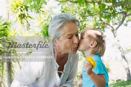 Petite fille embrassant grand-mère sur la joue