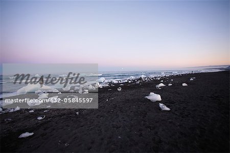 Gros morceaux de glace de glacier échouant sur la plage, le lagon glaciaire Jokulsarlon, Islande