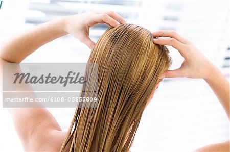 Young woman with wet hair, view from the back, close up (studio)