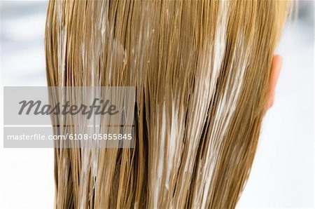 Young woman with hair mask, view from the back, close up (studio)