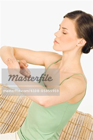 Woman meditating, shut eyes, tight hands