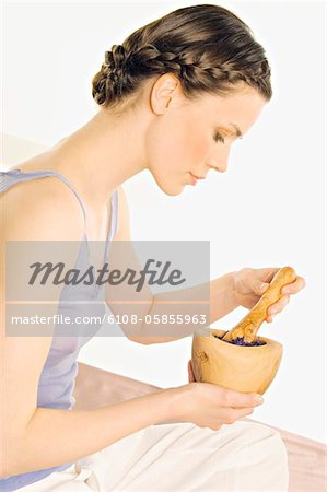 Woman with pestle and mortar