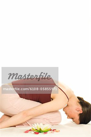 Woman relaxing, shut eyes, water lily