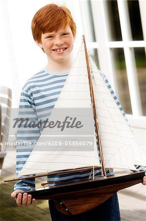 Boy holding a model boat