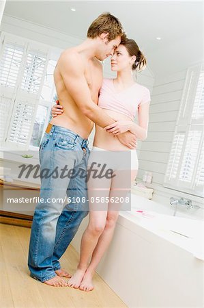 Couple embracing in bathroom