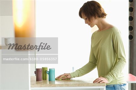 Young woman cleaning kitchen work-top