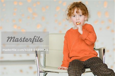 Little girl eating lollipop