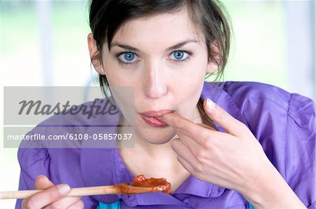 Portrait of a young woman tasting food