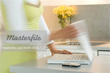 Woman opening a laptop, close-up