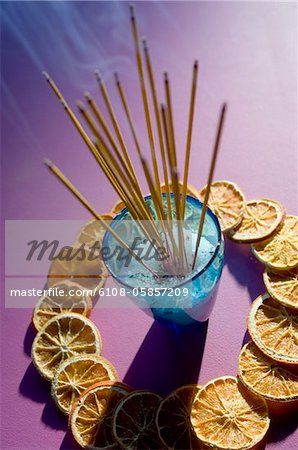 Insense sticks and dried orange slices, close-up