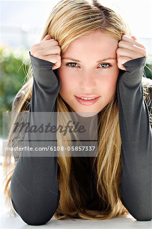 Portrait of a young woman looking at the camera, indoors (studio)