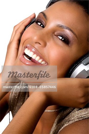 Portrait d'une jeune femme souriante, écouter de la musique avec un casque