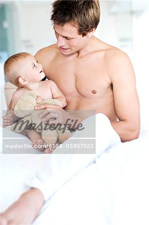 Father and baby sitting indoors