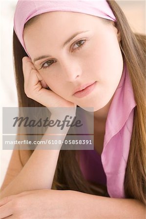 Portrait of a young woman looking at the camera, indoors