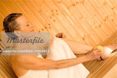 Senior woman sitting in sauna