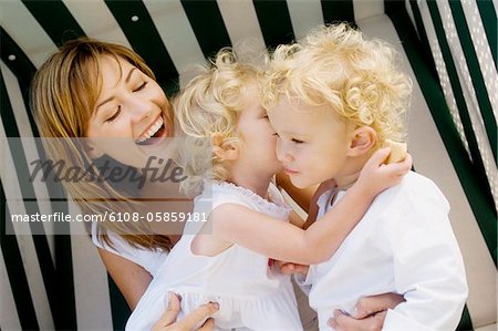 Mother and 2 children on a swing chair