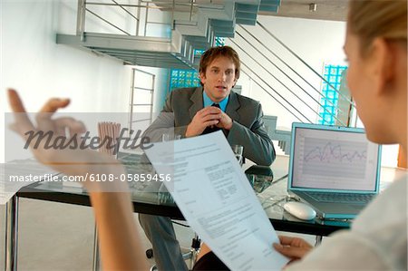 Businesswoman taking interview of young man