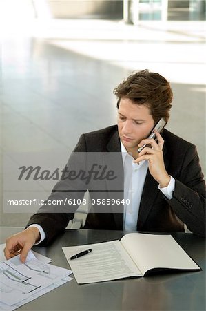 Businessman talking on a mobile phone at a desk