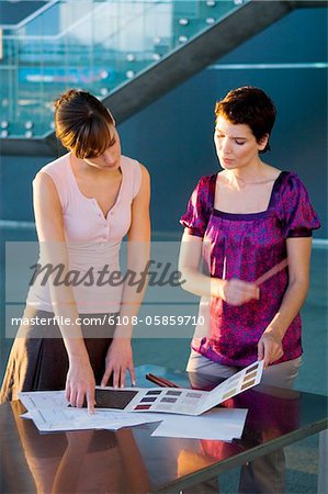 Two interior designers discussing on a color swatch