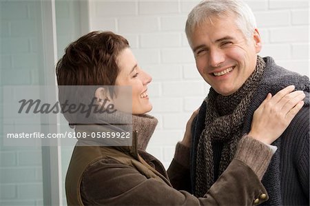 Mature man and a mid adult woman smiling