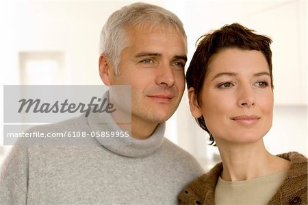 Close-up of a mature man and a mid adult woman looking away
