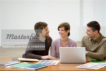 Mid adult man and a young woman discussing with an interior designer