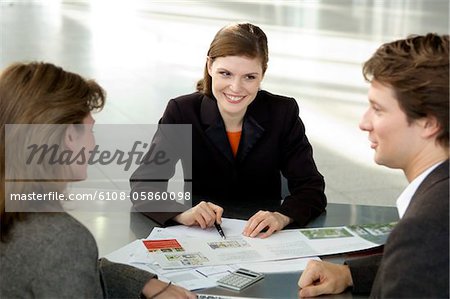 Real estate agent explaining to a couple