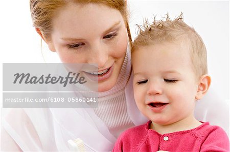 Young woman and her son looking at toothbrush