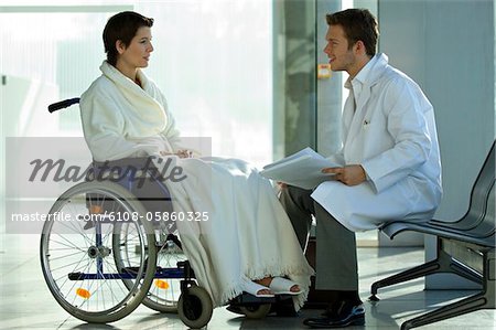 Side profile of a male doctor talking with a female patient