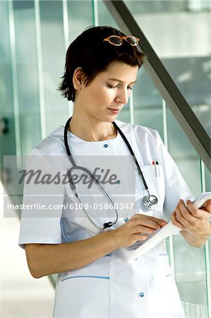 Female doctor reading medical records