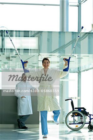 Female patient standing on one leg and holding crutches