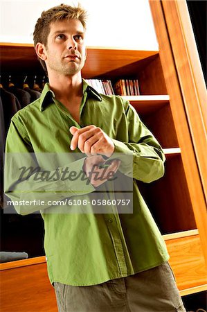 Reflection of a mid adult man getting dressed