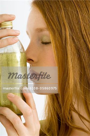 Nahaufnahme einer jungen Frau eine Flasche Aromatherapie Öl riechen