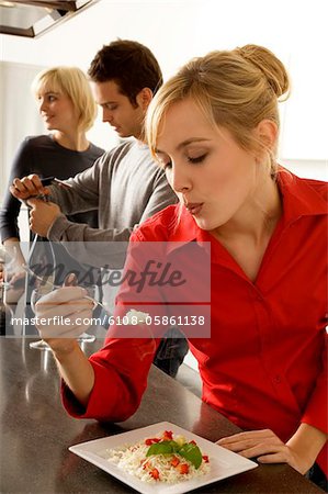 Young woman eating rice with a fork