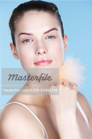 Young woman holding powder puff