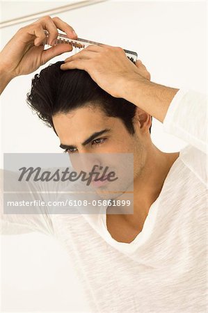 Close-up of a man combing his hair
