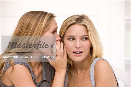 Close-up of two women gossiping