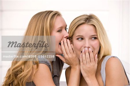 Close-up of two women gossiping