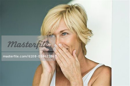 Woman talking on a mobile phone and surprised